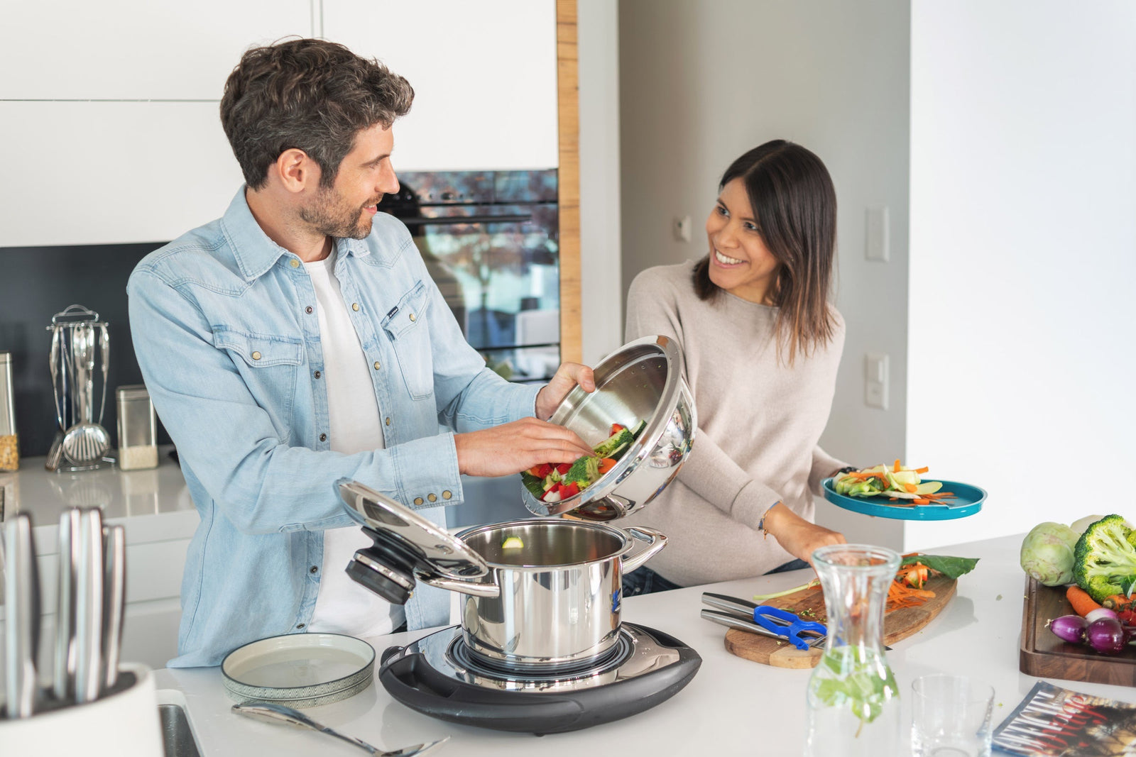 A couple cooking vegetables together in AMC cookware